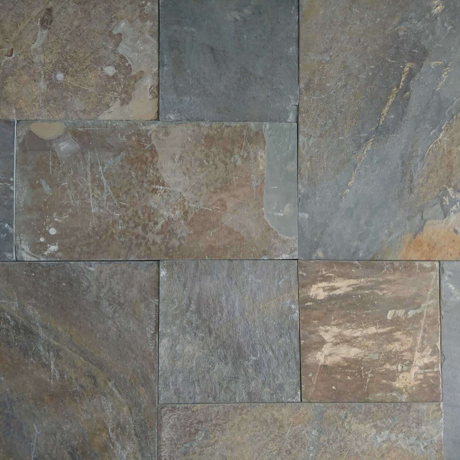 A close-up of a textured stone tile floor highlights the Strata 22mm Calibrated Rustic Slate, featuring earthy tones like gray, brown, and hints of blue. The tiles display a natural, slightly rough surface with visible variations and patterns.