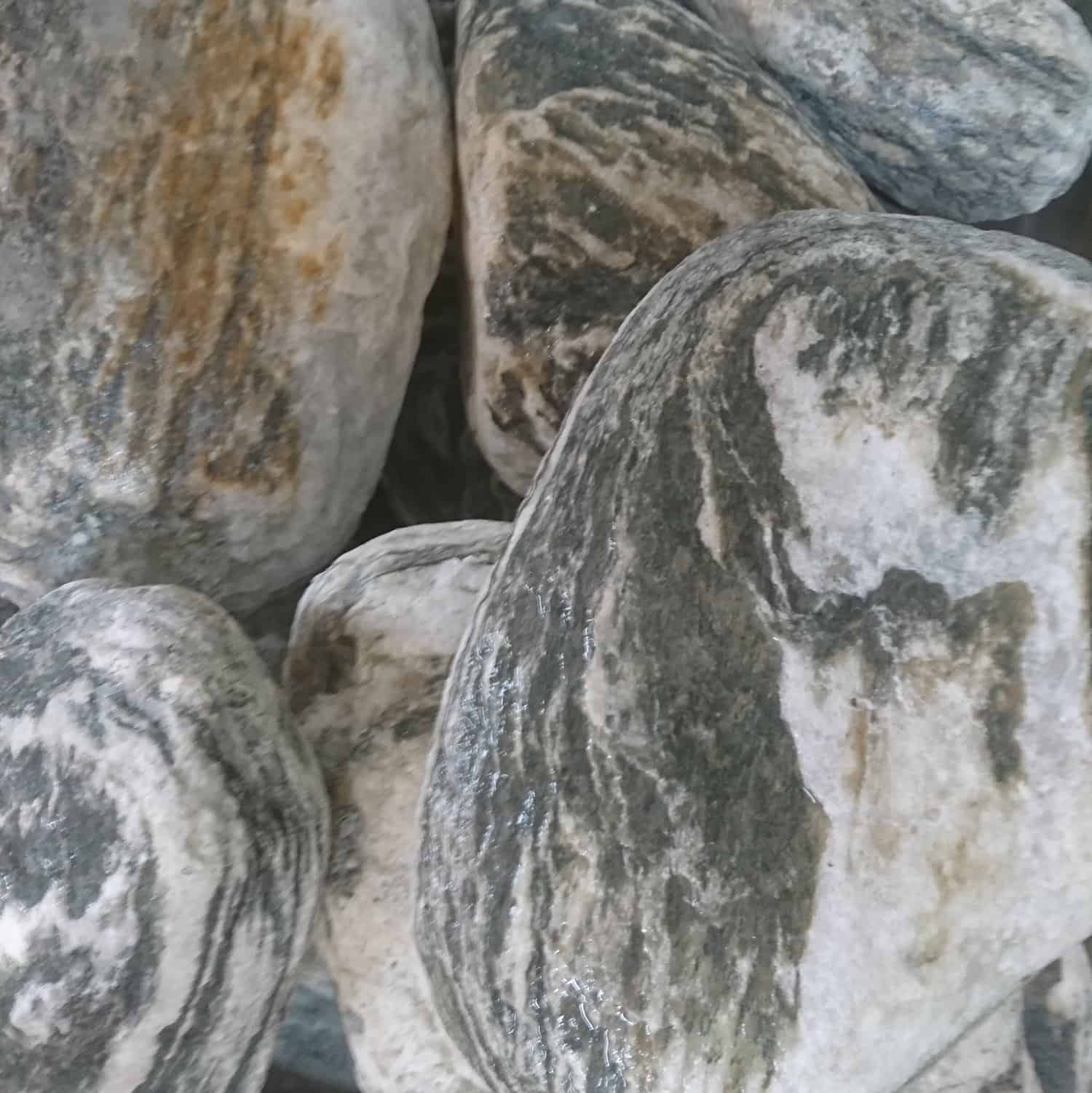 A close-up of 200-300mm Angel Whirlpool Boulders shows smooth stones in gray, white, and brown hues with organic patterns and textures that mimic natural mineral formations.