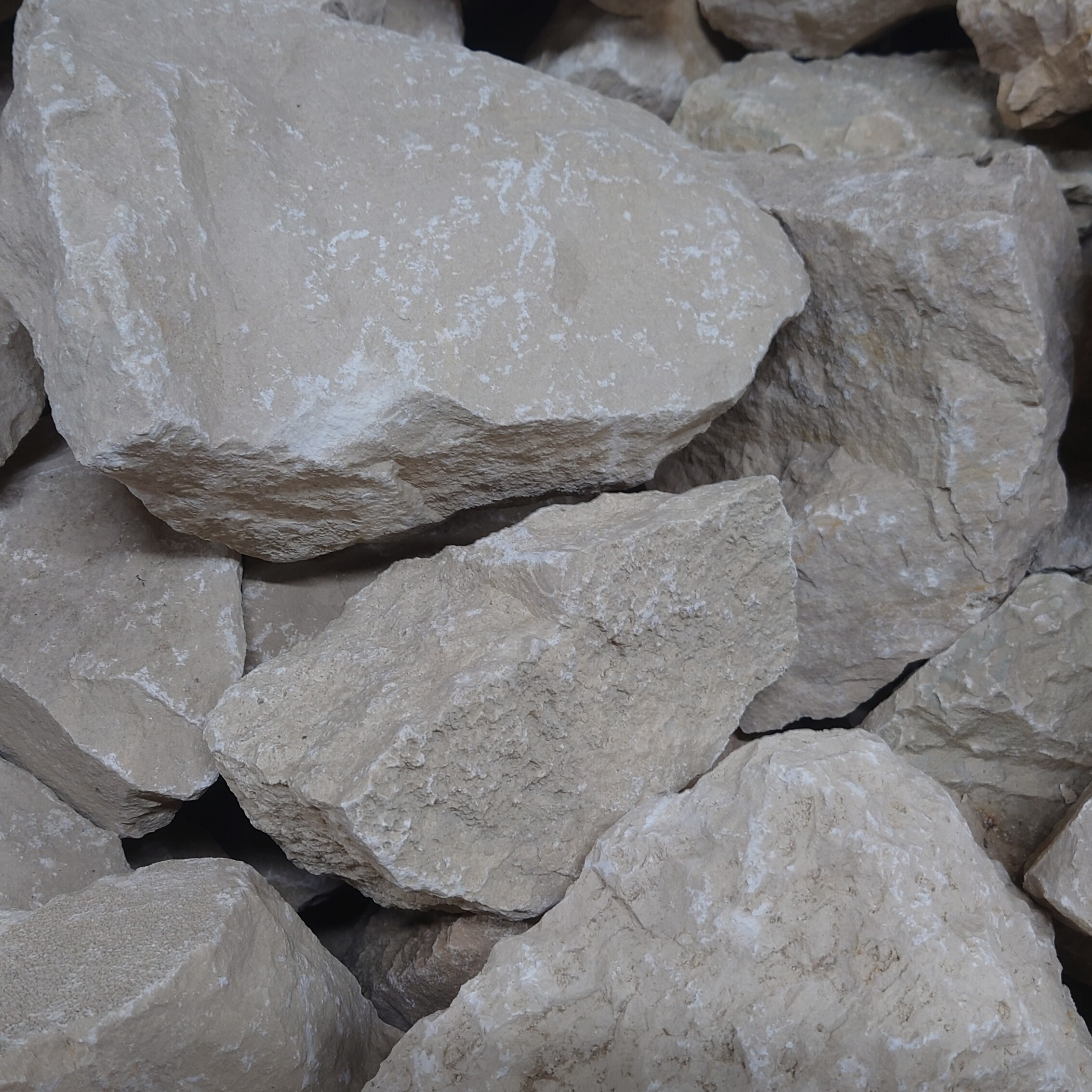 A close-up of 300-400mm Yorkstone Rockery shows several rough, light beige stones with uneven edges and textured surfaces stacked together.