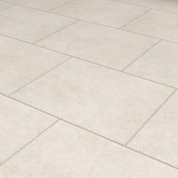 Premier Panache Pearl Porcelain tiles (900mm x 600mm x 20mm) arranged in an offset pattern feature visible grout lines and a subtle textured matte finish, creating a clean, uniform look.