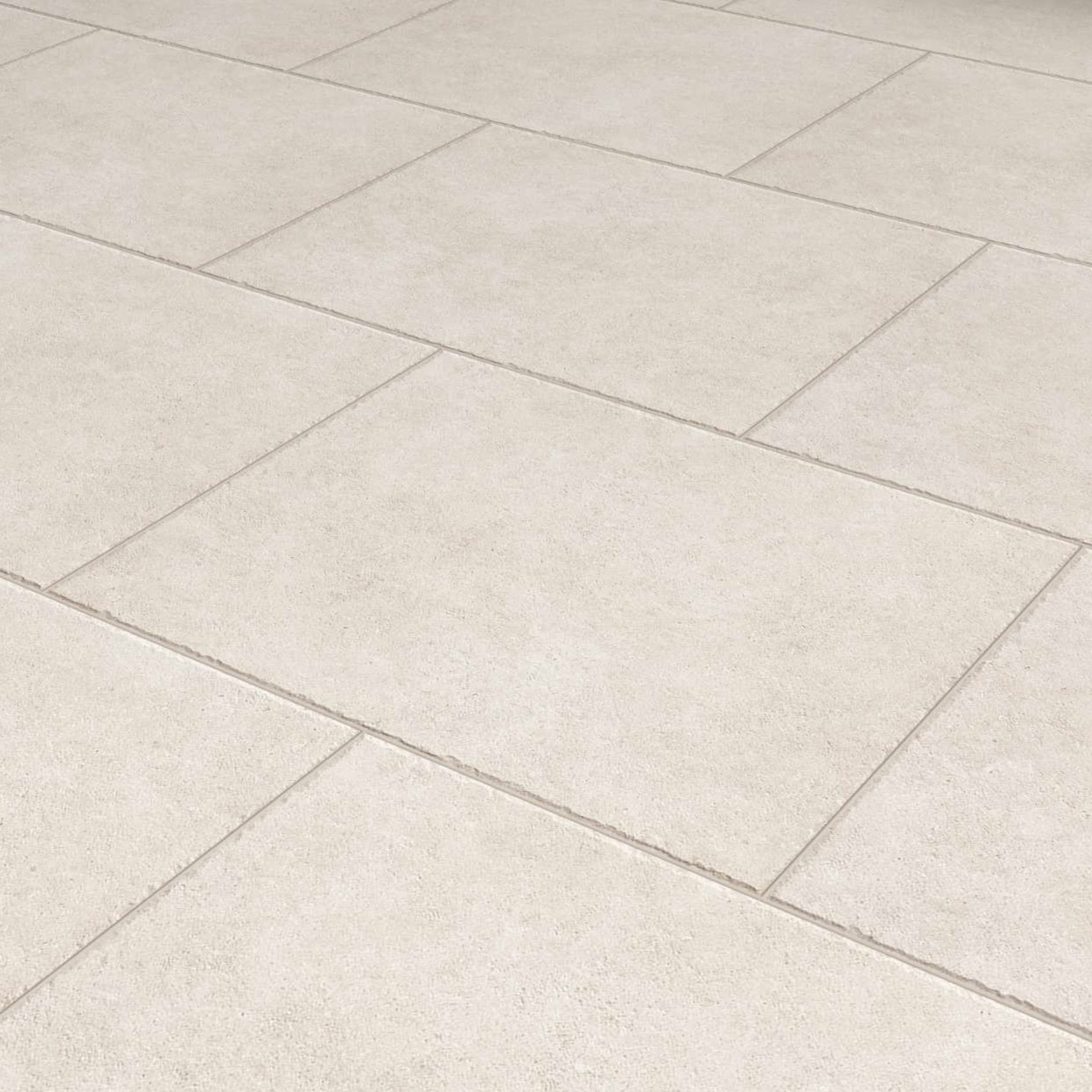 Premier Panache Pearl Porcelain tiles (900mm x 600mm x 20mm) arranged in an offset pattern feature visible grout lines and a subtle textured matte finish, creating a clean, uniform look.