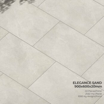 Rectangular sand-toned porcelain tiles with subtle veining and speckles, shown in a staggered layout. Text: "Premier Elegance Sand 21.6m² Porcelain Pack 900x600x20mm". Shadow of leaves in the top left corner.