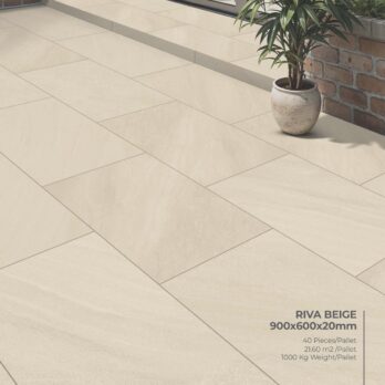 Premier Riva Beige 21.6m² Porcelain Pack: 900x600x20mm tiles, 40 pieces/pallet, covers 21.60 m², pallet weight 1000 kg—shown here on a patio beside a brick wall with a potted plant in a round ceramic pot.