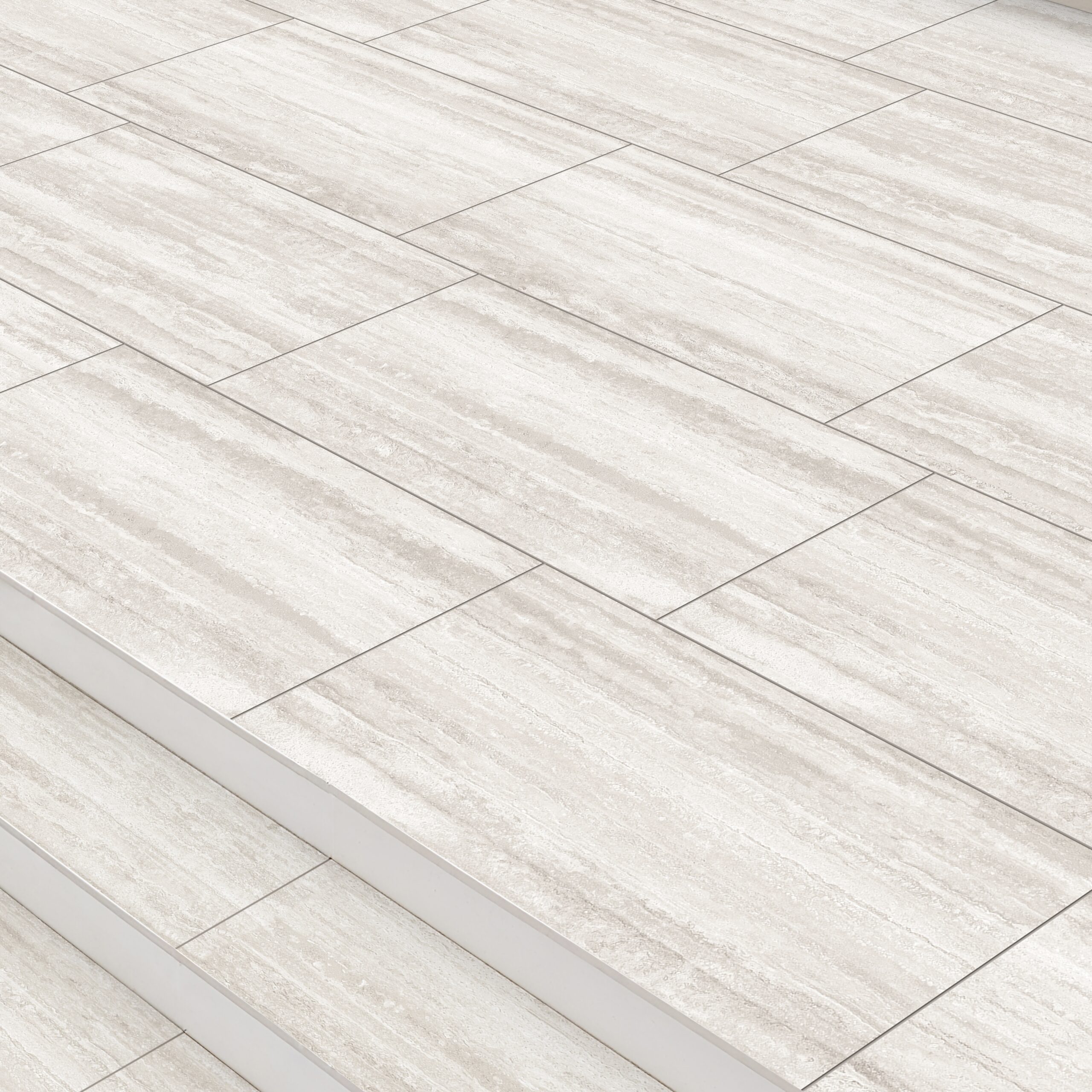 The Premier Grande Travertine Silver 21.6m2 Porcelain Pack features light beige tiles with subtle veining, arranged in a staggered pattern to bring clean, modern elegance to floors and steps in any space.
