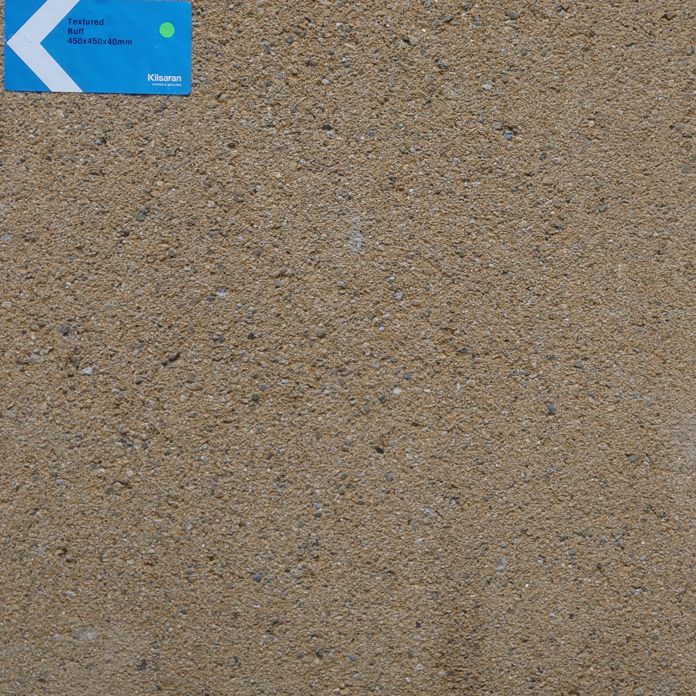 A close-up of a textured beige surface with a small blue label in the top left corner displaying 