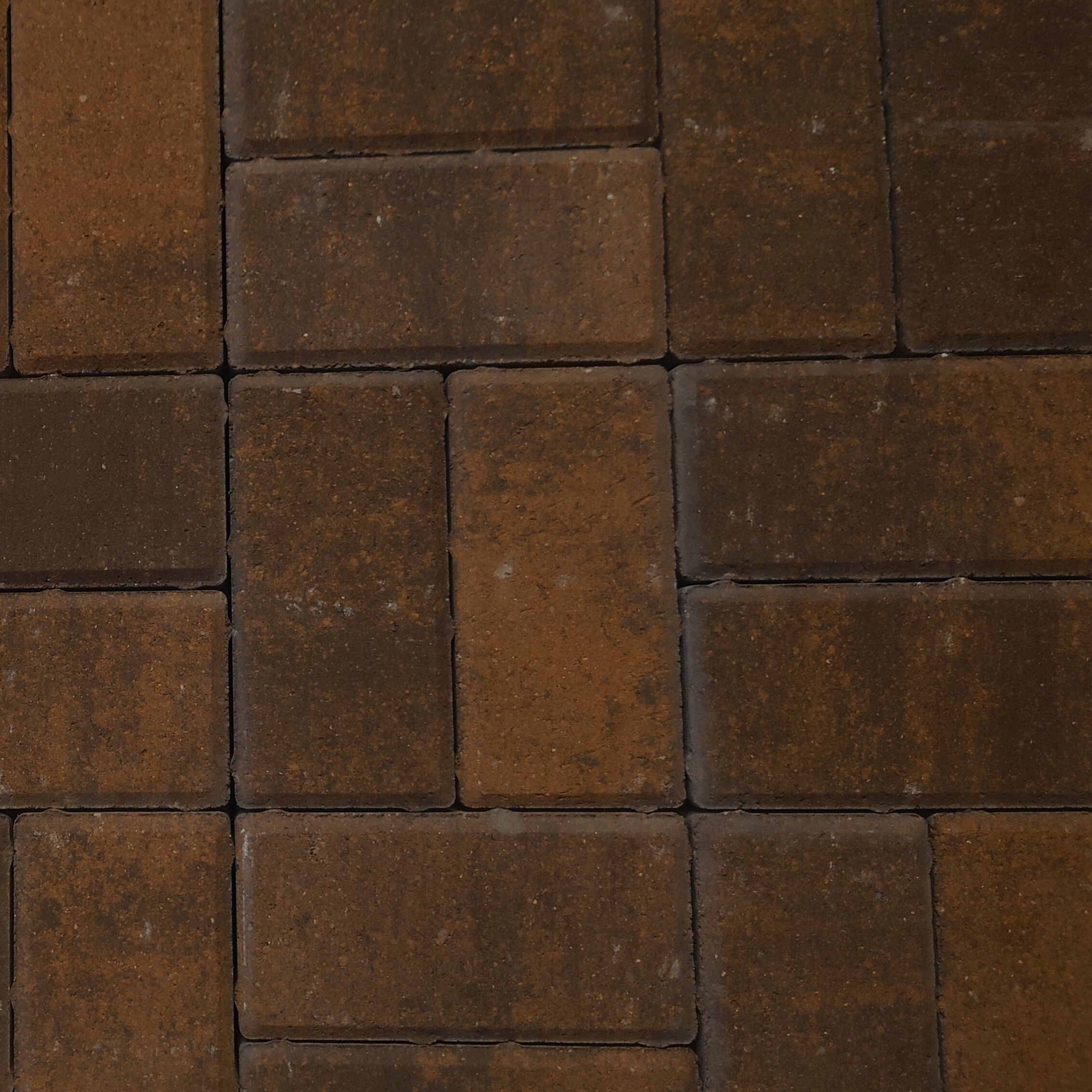 Close-up view of Kilsaran Slane 50mm Driveway Curragh Gold block paving arranged in a grid pattern, featuring rectangular bricks with subtle color and texture variations.