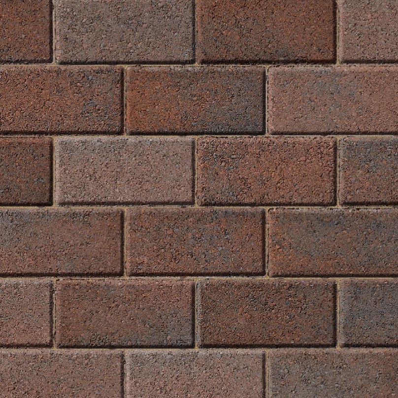 A close-up of a brick wall showcases the Kilsaran Slane 50mm Driveway Brindle, featuring rectangular red and brown blocks in a staggered pattern with thin mortar lines.