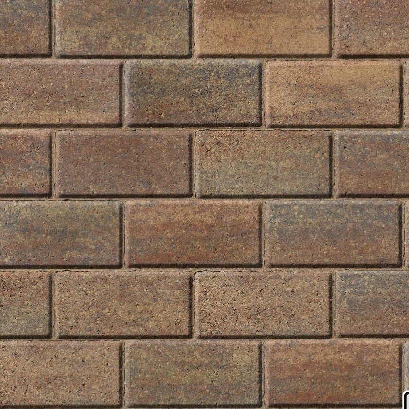 A close-up of a brick wall showcases Kilsaran Slane 50mm Driveway Rustic block paving, with rectangular bricks in brown, tan, and reddish-brown shades arranged in a staggered horizontal pattern.