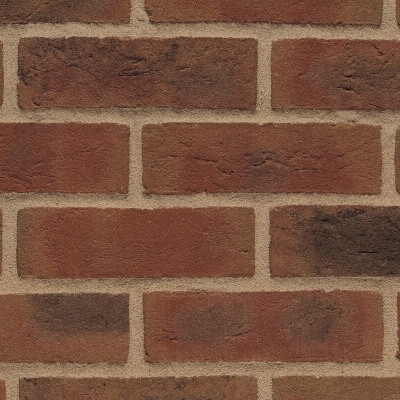 A close-up of an Olde Henfield Multi Red 65mm brick wall, highlighting the reddish-brown bricks and tan mortar laid in a neat horizontal pattern.