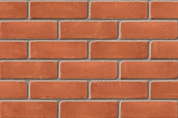 Red brick wall built with Leicester Stock Red 65mm bricks, arranged in neat horizontal and vertical rows with light gray mortar joints for a clean, uniform look.